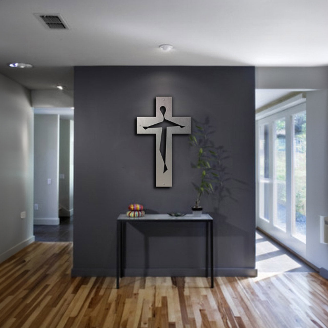 Modern metal artwork cross on room divider in a contemporary space.