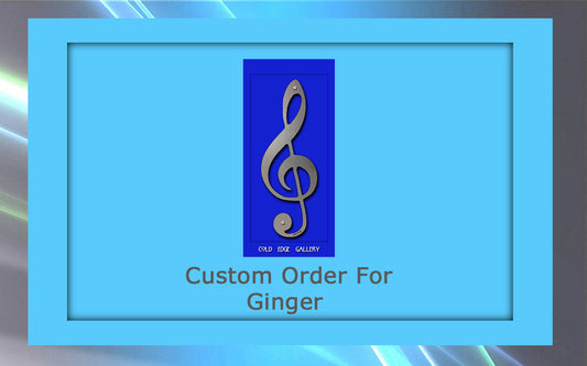 A blue framed graphic featuring a metal treble clef symbol. Text below reads "Custom Order For Ginger" with the words "Cold Edge Gallery" at the top, showcasing bespoke artwork.