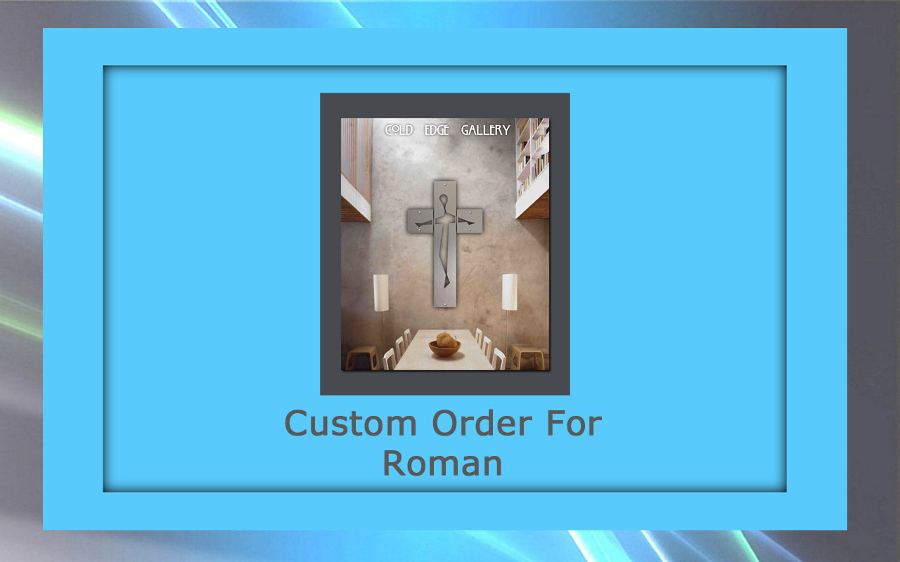 A framed artwork featuring a metallic cross on a gray wall is displayed in a blue frame. Text reads "Custom Order for Roman" and "Cold Edge Gallery." A custom wooden table and chairs are beneath the cross.