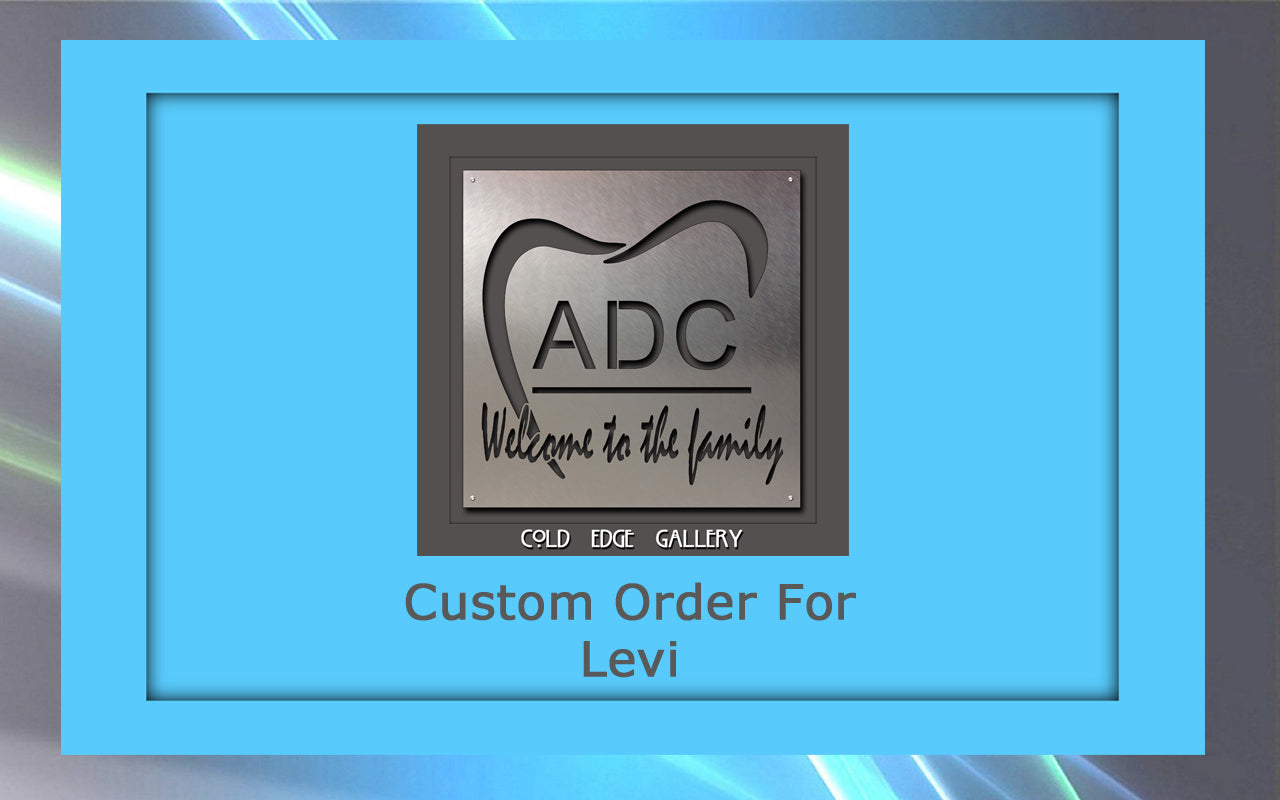 A framed metal artwork featuring a tooth design and the text "ADC Welcome to the family." Below, "Custom Order For Levi" on a light blue background.