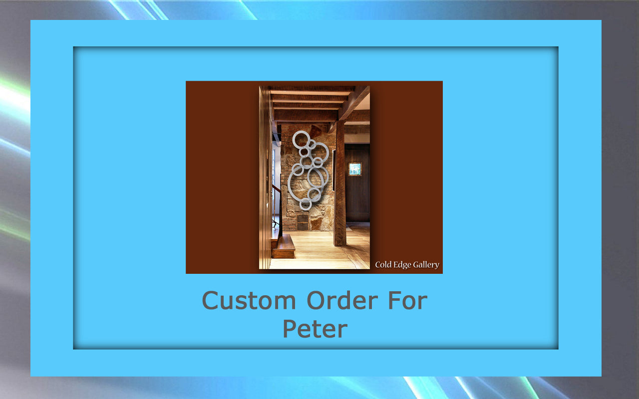 Framed interior photo showcasing custom metal artwork in a wood-finished hallway. Text: "Custom Order For Peter" and "Cold Edge Gallery" at the bottom.