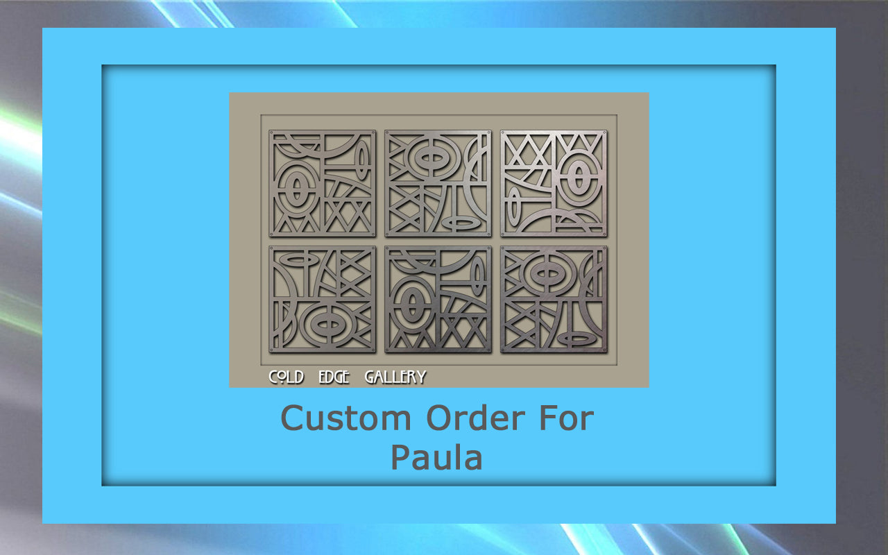 Image of a framed artwork with intricate geometric patterns. Text below the artwork reads "Custom Order For Paula" and "Cold Edge Gallery." The frame is blue with a gradient background, highlighting the meticulous detail of the custom metal design.