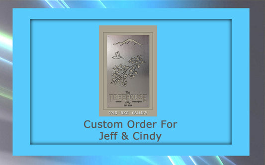 A metal plaque inside a blue frame reads "Custom Order For Jeff & Cindy" and features "The TREEHOUSE" with nature imagery and the text "COLD EDGE GALLERY".