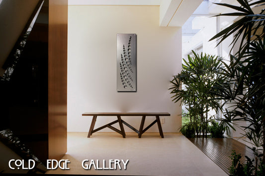 A modern bench and potted plants are arranged in a minimalist indoor setting with custom metal artwork on the wall. Text reads "Cold Edge Gallery.