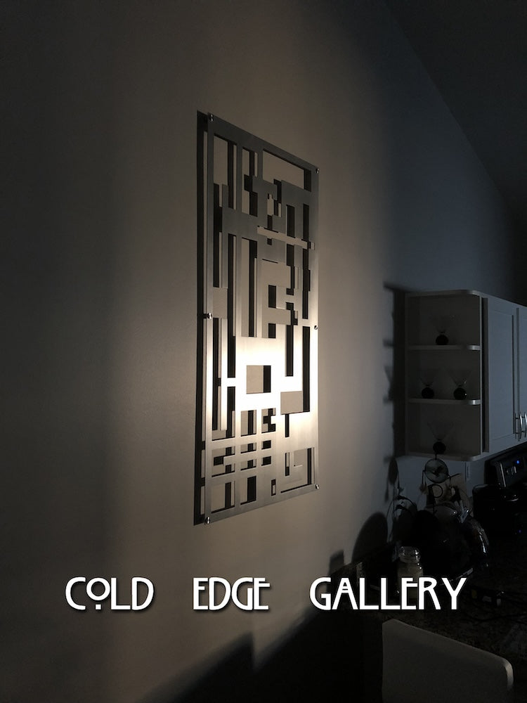 A geometric metal wall art piece, backlit, is displayed on a gray wall in a dimly lit room. The text "COLD EDGE GALLERY" is overlaid at the bottom.