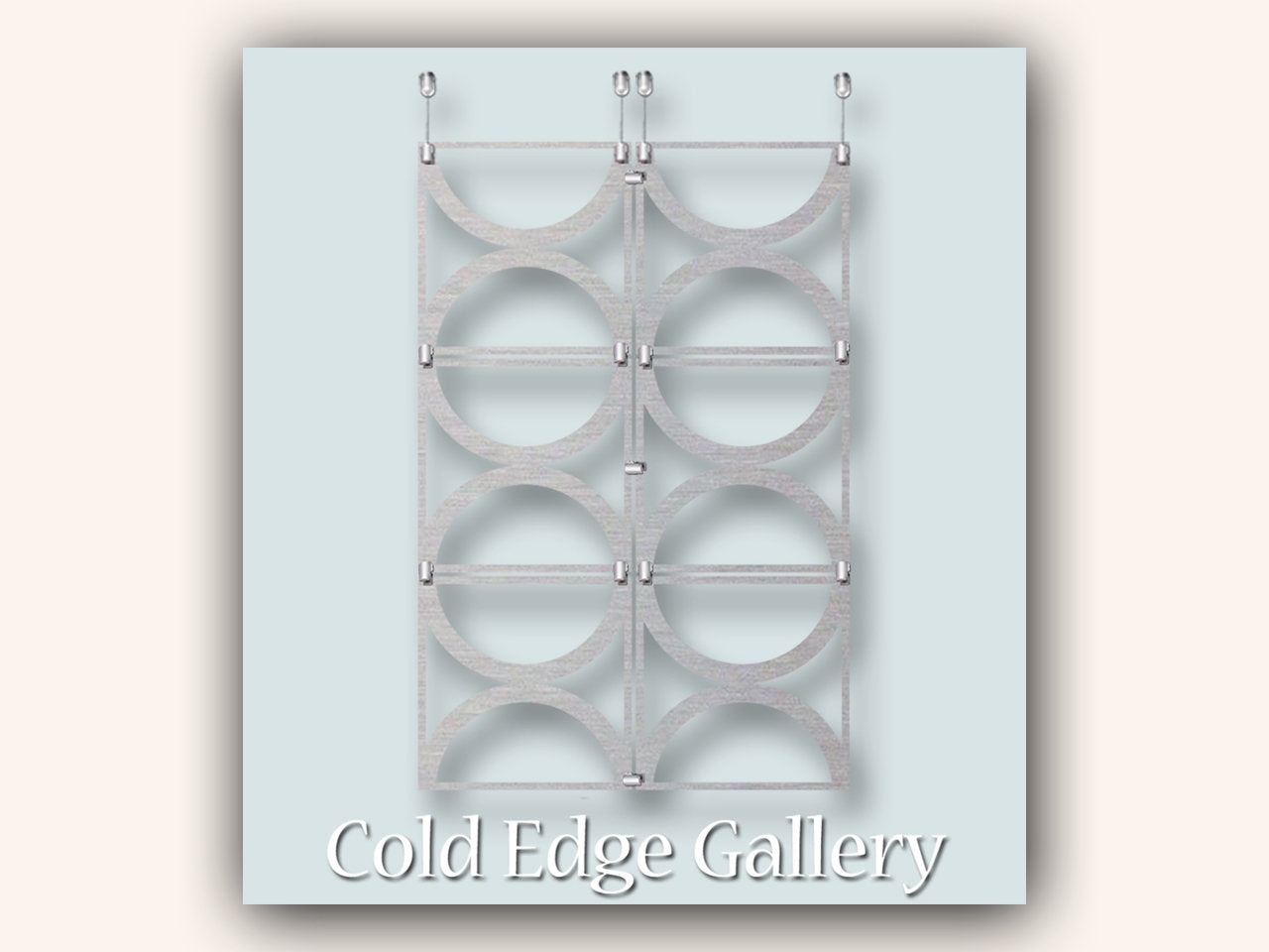 A symmetrical display of six vertical metal rings mounted on a light blue and beige background titled "Cold Edge Gallery.