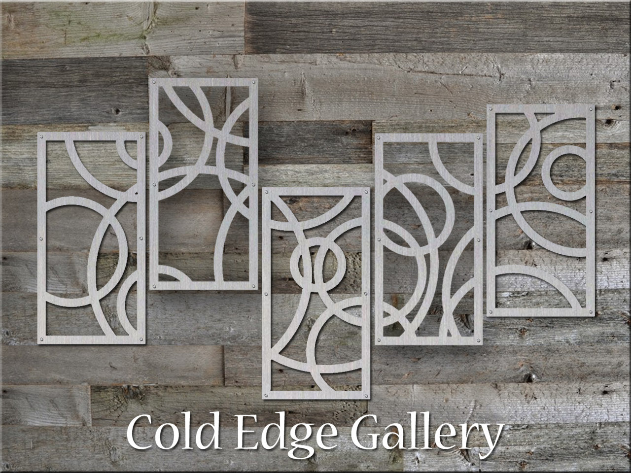 A metallic artwork featuring five rectangular panels with abstract circular designs is mounted on a wooden wall, with the text "Cold Edge Gallery" at the bottom.