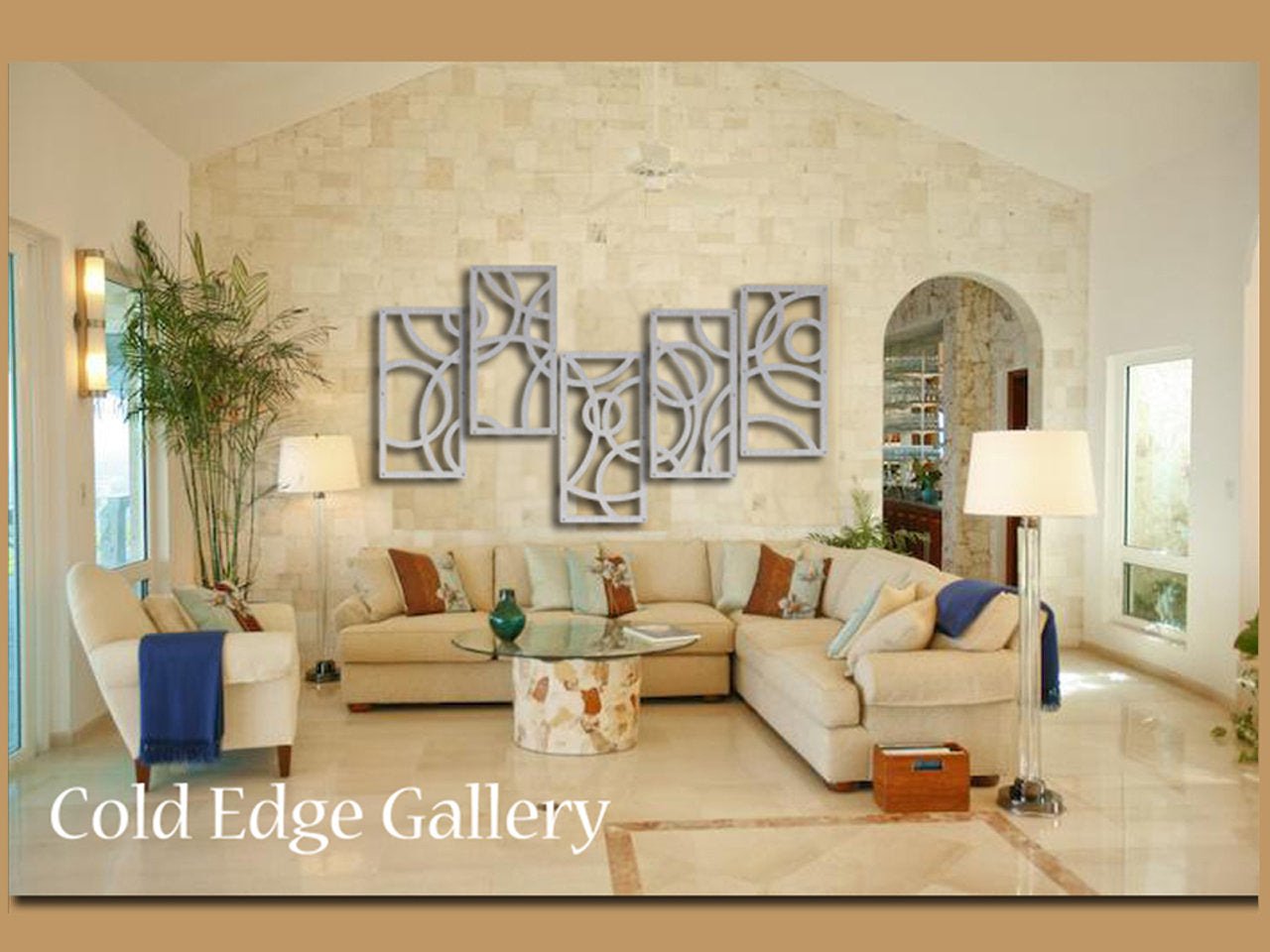 Spacious living room with beige sectional sofa, abstract metal wall art, potted plants, and modern decor. Labeled "Cold Edge Gallery.